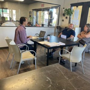 DNExpress advisor meeting with clients at a consultation table