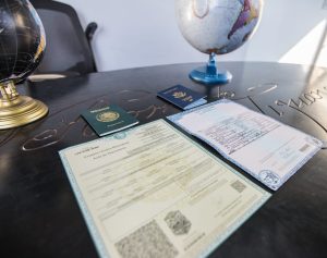 Mexican birth certificates and passports laid out on a table