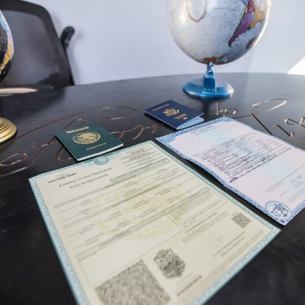 Mexican birth certificates and passports laid out on a table