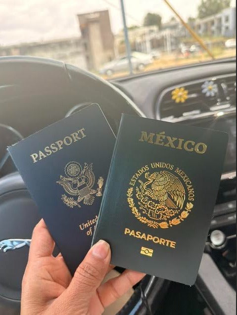 Hand holding Mexican and American passports showing dual citizenship approved